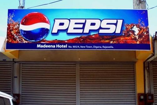Pepsi branded storefront sign above a shop entrance