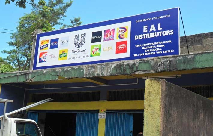 Unilever distributor sign mounted above a retail building