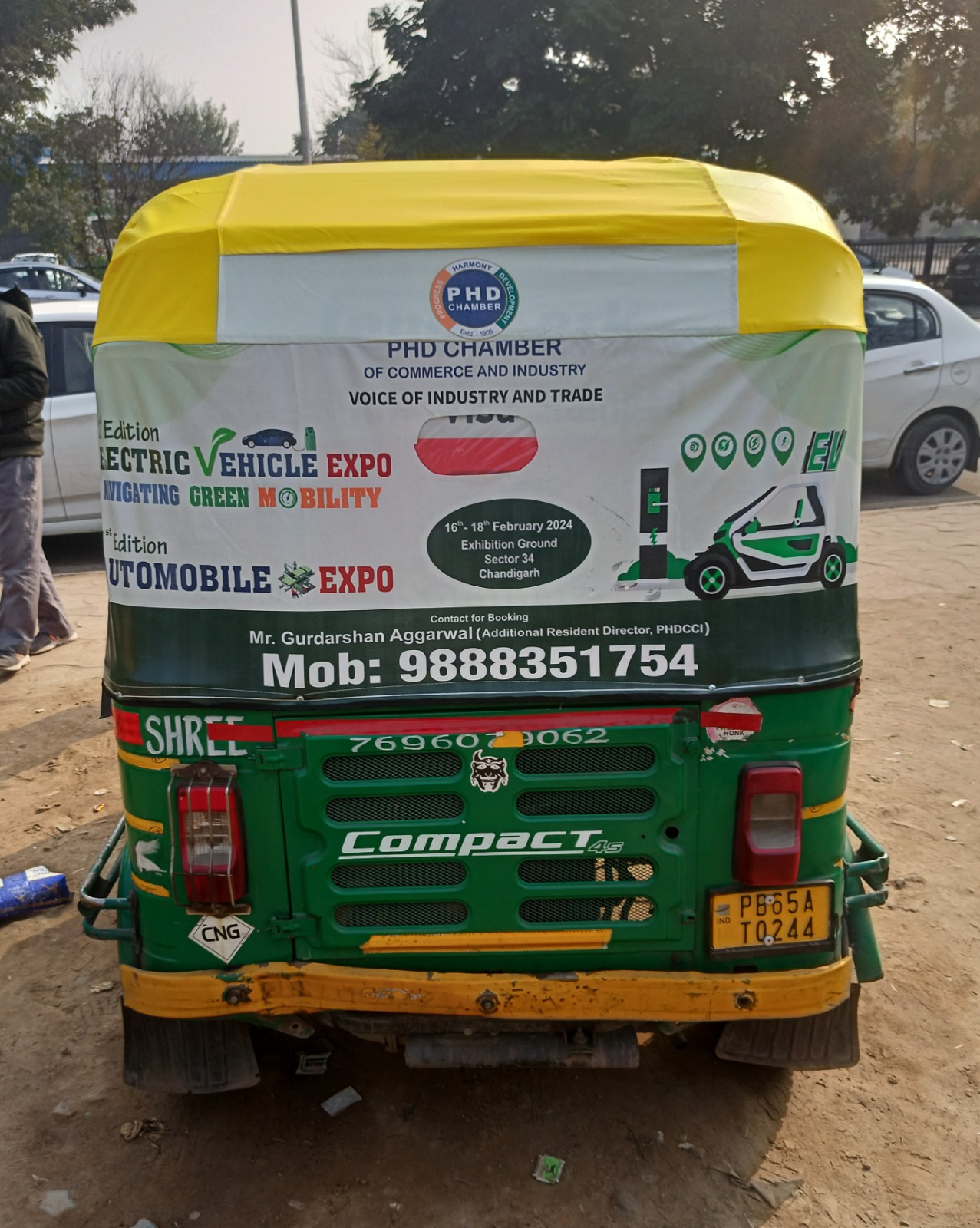 PHD Chamber electric vehicle expo advertisement on an auto-rickshaw