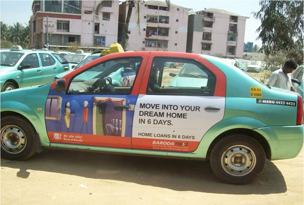 Bank of Baroda home loan advertising panels on a taxi